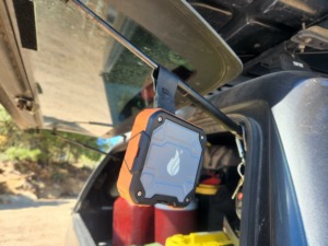 blackfire portable waterproof speaker hanging from rear truck window
