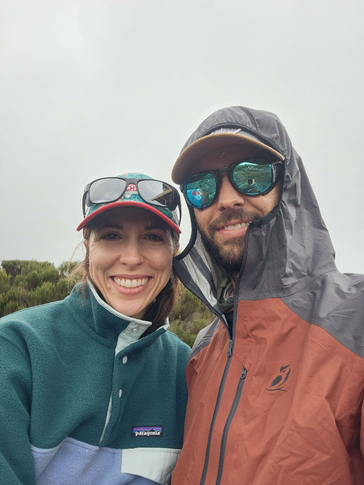 Couple on Kili climb with man wearing Tushar Rain Jacket