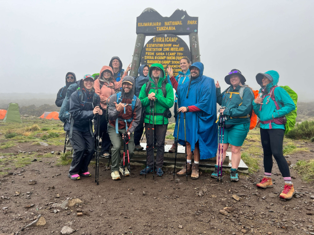 Group of hikers at Shira 1 Camp sign on Kilimanjaro hike