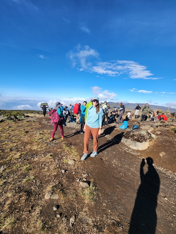 Woman wearing blue HOKA trekking boots