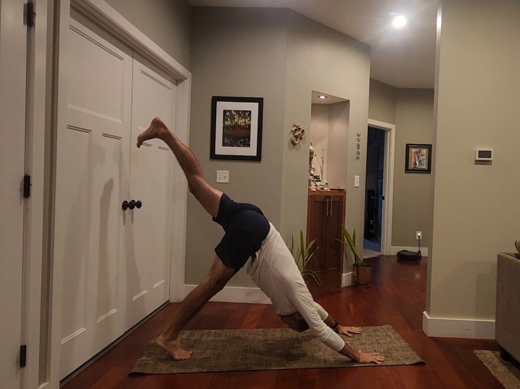 Man in challenging yoga pose not sweating thanks to ASRV Apparel