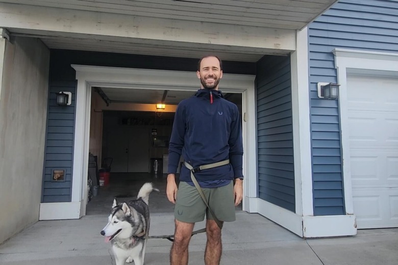 Man wearing ASRV training hoodie with dog